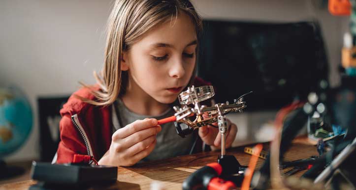 Pre-teen working on computer components