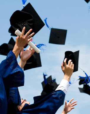 Graduates throwing caps in the air